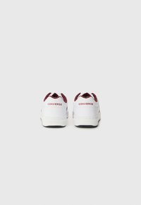 White sneakers with maroon accents and branding. Features a smooth leather upper, padded collar, and contrasting black rubber sole.