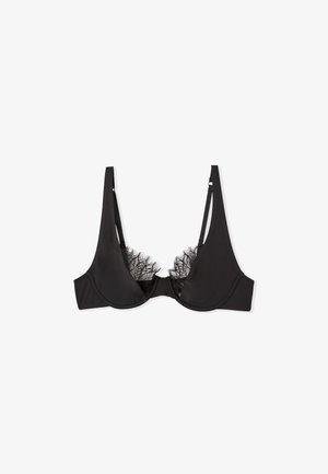 Soutien-gorge noir avec des détails en dentelle le long du décolleté, bonnets lisses, bretelles ajustables et soutien par armatures. Sans rembourrage.