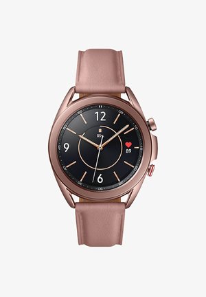 Round smartwatch with a black face, rose gold case, and light pink silicone strap. Features include a circular display and two side buttons.