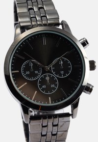 Silberner Metallarmbanduhr mit schwarzem Zifferblatt, drei Unterzifferblättern, linearen Stundenmarkierungen und einem polierten Gliederarmband.