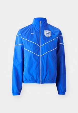 Blue nylon jacket with a high collar, zippered front, elastic cuffs, and waistband; features white accents and an England crest on the chest.