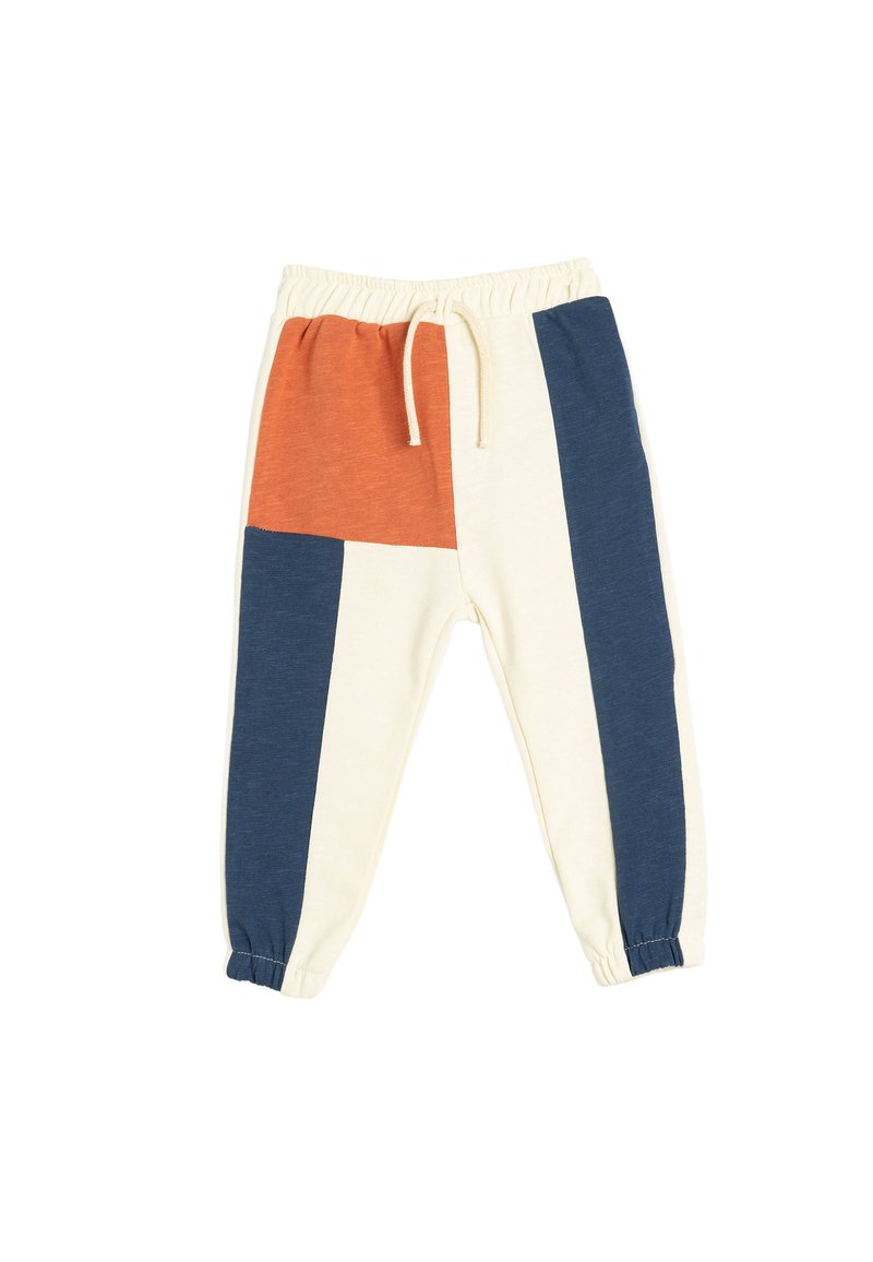 Pantalones de chándal con bloque de color que presentan paneles en crema, azul marino y óxido, con cintura elástica y puños, y un cordón para ajustarlos.