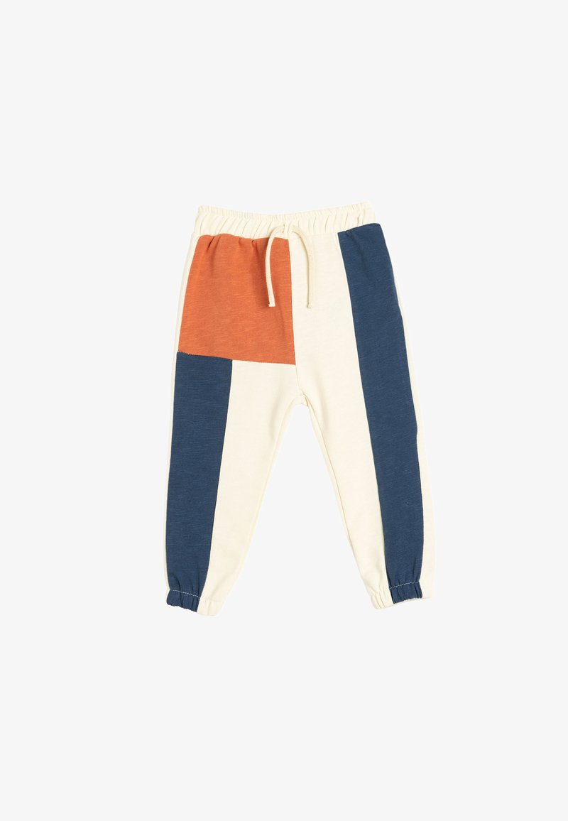 Pantalones de chándal con bloque de color que presentan paneles en crema, azul marino y óxido, con cintura elástica y puños, y un cordón para ajustarlos.