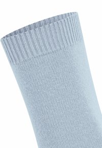 Tessuto lavorato a maglia azzurro chiaro con polsino a coste, che mostra una trama e un motivo di cucitura dettagliati.