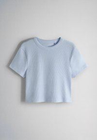 Light blue short-sleeve ribbed crop top with round neckline displayed on a plain gray background.
