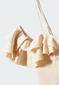 Helles beige, schulterfreies Oberteil mit geschichteten Rüscheldetails, aus glattem Stoff gefertigt. Verfügt über dünne Träger und ein strukturiertes Design.