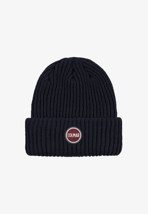 Marineblauwe gebreide beanie met ribbelstructuur, voorzien van een omgeslagen rand en een ronde Colmar-logo patch in rood en wit aan de voorkant.
