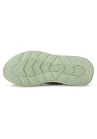 Shoe sole in green rubber with a textured pattern featuring geometric shapes and grooves for traction. Flat with a rounded edge.