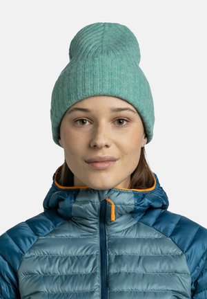 Blue-green knitted beanie with a ribbed texture and rounded top. Paired with a blue puffy jacket featuring an orange zipper accent.