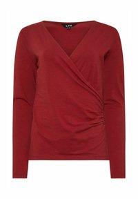 Top rosso a maniche lunghe con scollatura a V e design avvolgente, caratterizzato da dettagli arricciati sul lato, realizzato in un tessuto morbido e elastico.