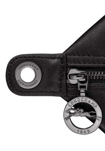 Black leather zipper pull featuring a round metallic charm with a running horse design, embossed logo, and sleek zip detail.