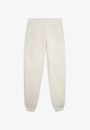 Pantalones de chándal color crema confeccionados en material suave, con una cintura elástica, bolsillos laterales y puños ajustados en los tobillos.