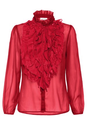 Pika punane läbipaistev pluus, millel on ees kihilised volangid ja kõrge volangikrae, nööbitud esiosa keskelt.