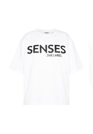 White cotton T-shirt with short sleeves, featuring bold black text that reads "SENSES .THE LABEL" across the front. Relaxed fit.