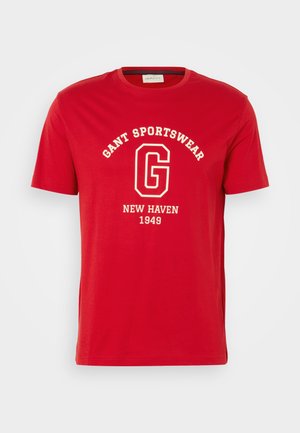 Red short-sleeve t-shirt made of cotton, featuring a white text print of "GANT SPORTSWEAR," and "NEW HAVEN 1949" in a classic font.