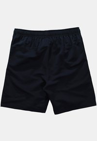 Bañador negro con cinturilla elástica, textura suave y corte recto. Sin bolsillos visibles ni patrones. Diseño sencillo.