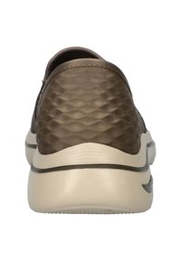 Brown slip-on shoe with a textured, diamond-patterned fabric upper and a light beige rubber sole, featuring a smooth back and minimal accents.