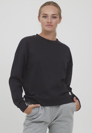 Black sweatshirt with a round neck, loose fit, and long sleeves. Made of a soft fabric, featuring a small brand label on the hem.