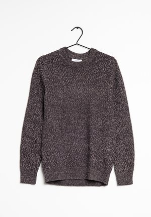 Pull en tricot gris foncé chiné avec col rond et manches longues suspendu sur un cintre noir contre un fond blanc.
