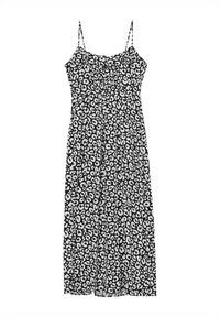 Robe léopard noir et blanc avec des fines bretelles ajustables, corsage ajusté et jupe fluide, arrivant aux genoux. Texture de tissu lisse.