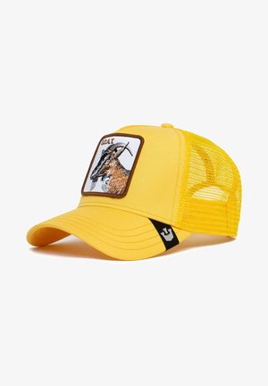 Cappellino da camionista giallo con un patch ricamato marrone e bianco che rappresenta una capra. Parte posteriore in rete e visiera curvata. Accento nero sul lato.