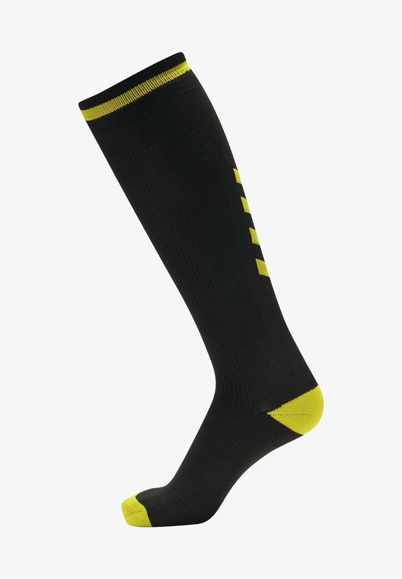 Svarta knästrumpor med ljusgula accenter upptill, på tån och hälen, med en ribbad struktur och randigt mönster på sidan.