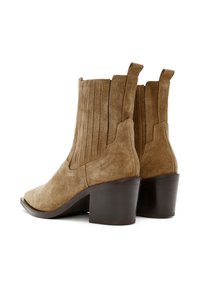 Pair of brown suede ankle boots with stacked dark wooden heels, pull tabs, and ribbed elastic side panels against a white background.