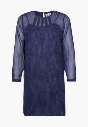 Granatowa sukienka z długimi, przezroczystymi rękawami, ozdobiona małymi białymi kropkami, z plisowanym przodem i zamknięciem na klucz z tyłu.