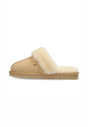 Beige slipper with sheepskin lining, open back design, smooth exterior, and a textured sole for grip. Features subtle logo detailing.