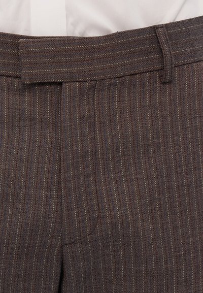 Brown pinstripe trousers featuring a smooth texture, a flat front, button closure, and belt loops. The fabric has subtle multicolored threads.