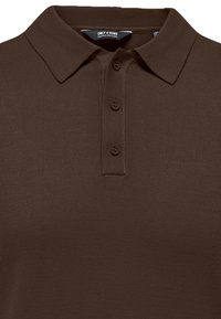 Polo marron en maille avec petit col et trois boutons sur la patte de boutonnage, avec l'étiquette de la marque Only & Sons à l'intérieur du col.