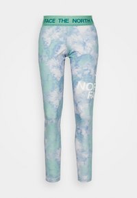 Leggings i ett tie-dye-mönster av ljusblått och grönt. Har en bred midja med "THE NORTH FACE"-logotyp i vitt. Mjuk tygkvalitet.