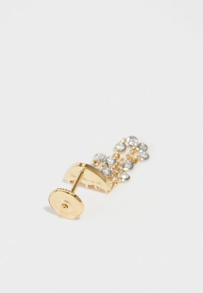 Gold-tone earring with a curved design, featuring three strands of clear gemstones, attached by a back post and disc fastener.