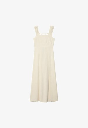 Robe maxi sans manches, de couleur crème, avec un corps ajusté, des bretelles texturées et une fente latérale pour faciliter le mouvement. Tissu doux et léger.