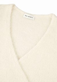 V-kaelusega sviiter pehmest kreemjas värvitoonis kudumifaas. Omab õrna tekstuuri ja 'OH APRIL' sildi kaeluses.