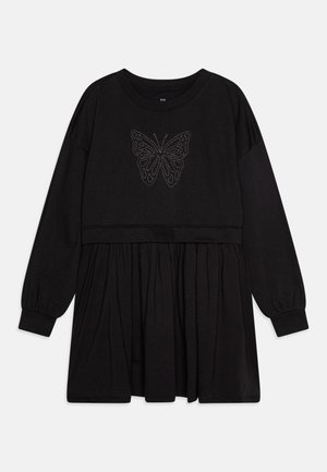 Czarna sukienka z długimi rękawami, o dopasowanej górze i rozkloszowanej spódnicy. Srebrny motyw motyla na klatce piersiowej. Miękka faktura materiału.
