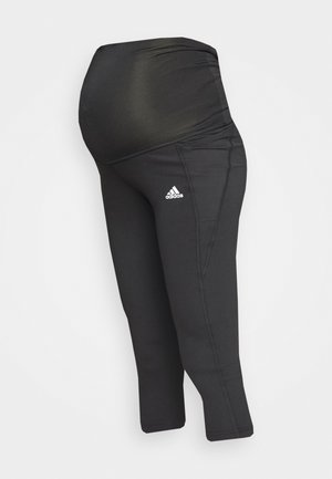 Schwarze Umstandsleggings mit hohem elastischem Bund und Adidas-Logo am Oberschenkel, entworfen für Komfort und Halt während der Schwangerschaft.