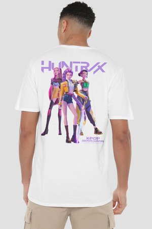 Man wearing a white T-shirt with colorful animated female characters and text "HUNTRX" and "KPOP DEMON HUNTERS" on the back.