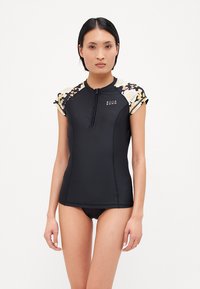 Black rash guard with short, floral print sleeves, front zipper, and logo detail on chest. Made from stretchy, lightweight material.