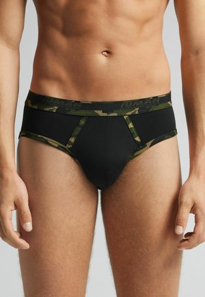 Schwarze Unterwäsche mit dunklem Camouflage-Bund und Details, die einen engen Sitz und eine glatte Textur bietet. Klassisches Slip-Design.