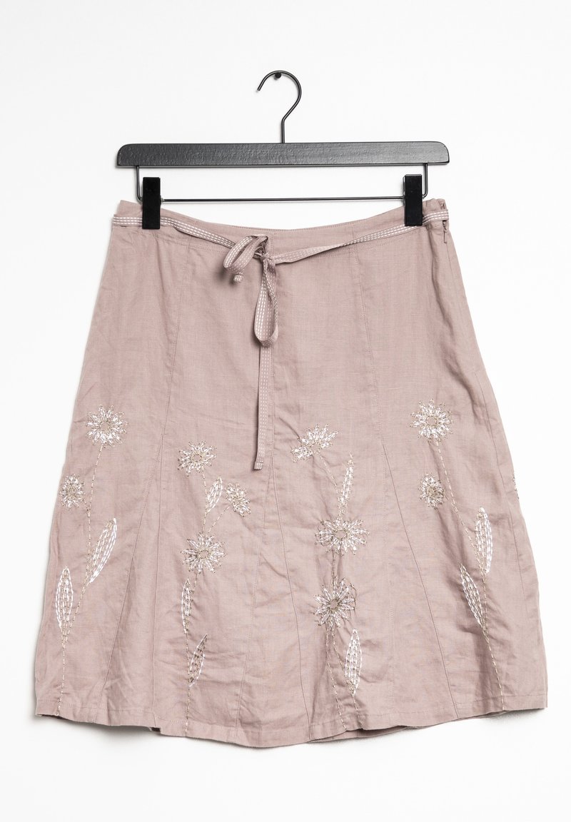 Light pink linen skirt with a tie waist, featuring floral embroidery in silver and white. Mid-length with a flat hem and textured finish.