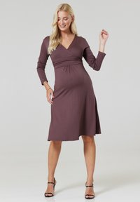 Brown, knee-length wrap dress with long sleeves, featuring a pleated detail at the waist and a side slit. Soft fabric texture and simple design.