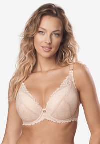 Biustonosz z koronkowym wykończeniem w jasnym beżu, o gładkim, teksturowanym wykończeniu, z dekoltem w kształcie litery V i regulowanymi ramiączkami z złotymi akcentami.