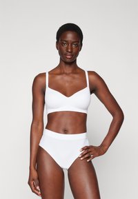 White bra and high-waisted underwear set. Smooth fabric with a subtle sheen. Thin straps; v-neckline for the bra; elastic waistband on underwear.