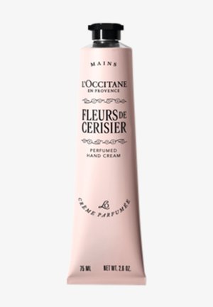 Crema per le mani L'Occitane in un tubo di metallo rosa, con testo nero e dettagli decorativi. Capacità di 75 ml (2,6 oz). Texture liscia.