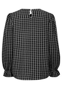 Blusa a quadri bianca e nera con maniche lunghe a palloncino, chiusura posteriore con bottoni e polsini arricciati. Tessuto leggero con motivo a griglia.