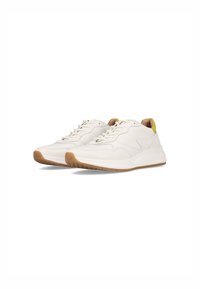 White sneakers with a smooth leather upper, textured accents, and a patterned gum sole. Yellow detail on the heel adds contrast.