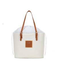Witte geweven tote bag met bruine leren handvaten en accenten. Het heeft een trekkoordsluiting en een rechthoekig leren label op de voorkant.