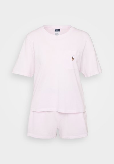 Light pink cotton pajama set featuring a short-sleeve shirt with a pocket and a small embroidered logo, paired with matching shorts.