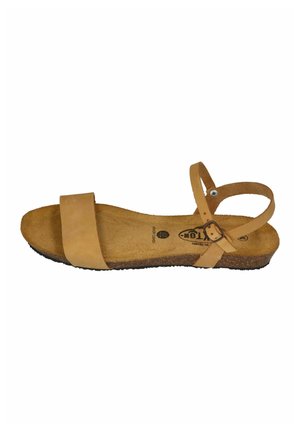 Tan open-toe sandal with a wide front strap, ankle strap with buckle, cushioned cork footbed, and black rubber sole.